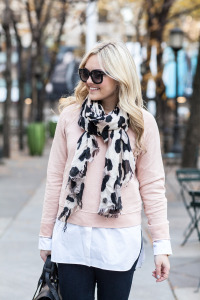 Style blogger Bows & Sequins wearing a blush pink sweater, leopard scarf, and sunglasses.
