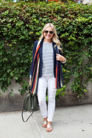Bows & Sequins wearing a striped shirt, blue blazer, and white jeans.
