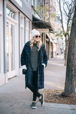 Bows & Sequins styling a plaid coat, turtleneck sweater, waxed jeans, and suede sneakers for winter.