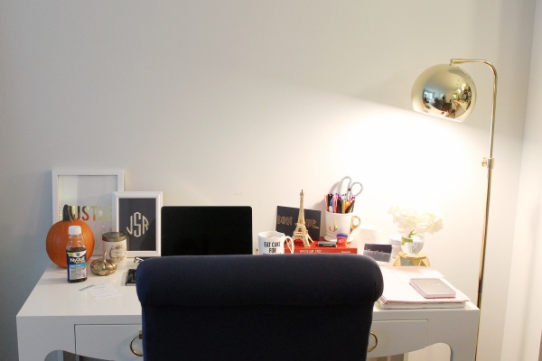 white desk, navy chair, gold floor lamp