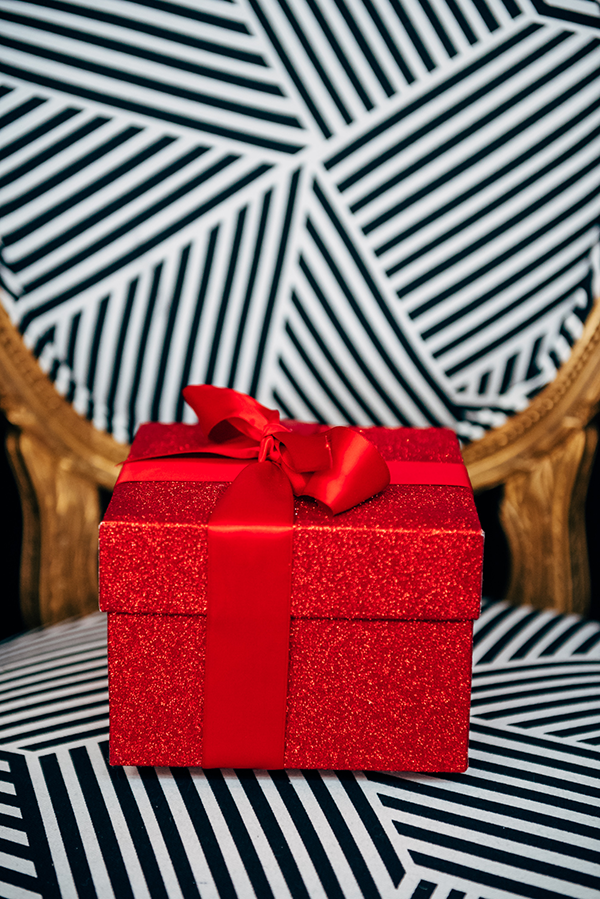 red glitter present gift box with a bow