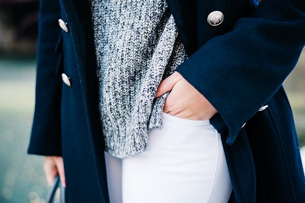 navy blue coat, grey sweater, white jeans