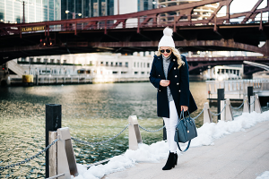 Bows & Sequins wearing a winter outfit with white jeans in Chicago.