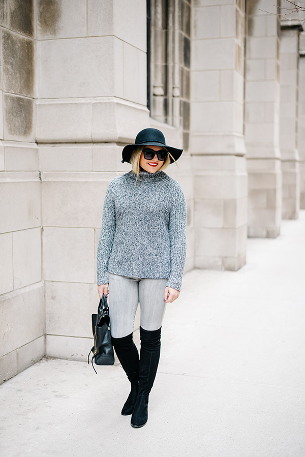 black over the knee boots with grey jeans