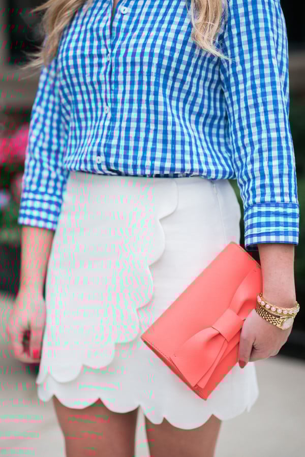 blue gingham shirt, white scalloped skirt, coral bow clutch