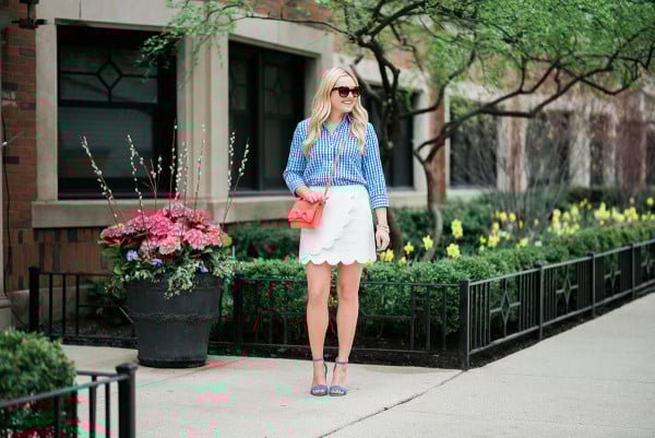 colorful spring outfit gingham shirt white skirt blue heels coral crossbody bag