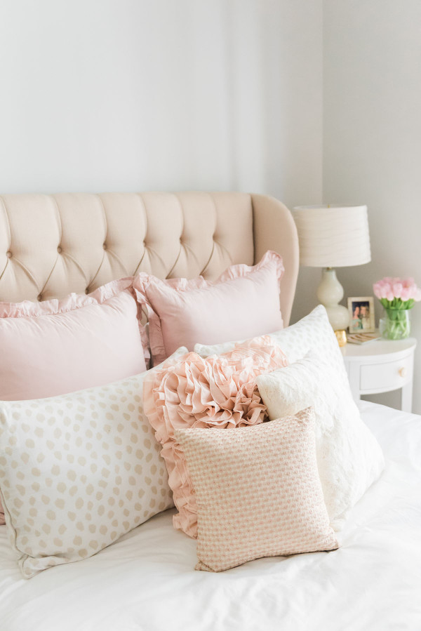 Blogger Jessica Sturdy of Bows & Sequins shares her Chicago Parisian-chic bedroom design. Tufted linen headboard, ruffled Crane & Canopy bedding, Ballard Designs spotted beige animal print shams.