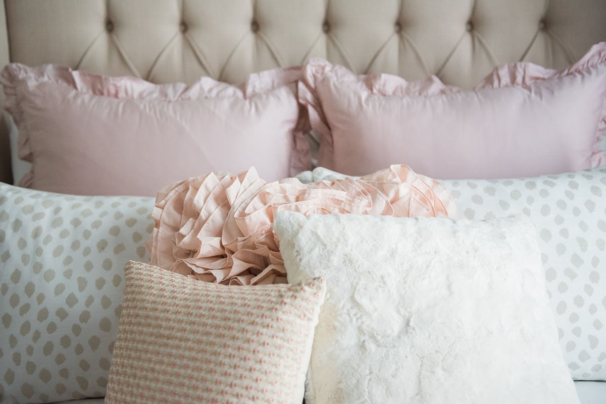 Blogger Jessica Sturdy of Bows & Sequins shares her Chicago Parisian-chic bedroom design. Tufted linen headboard, ruffled Crane & Canopy bedding, Ballard Designs spotted beige animal print shams, Pier 1 throw pillows.