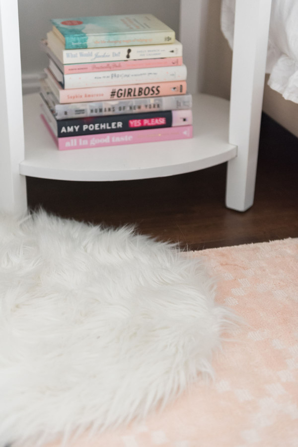 Blogger Jessica Sturdy of @bowsandsequins shares her Chicago Parisian-chic bedroom design. // Pier 1 Blush Pink Rug, Lulu & Georgia White Shag Rug, Pink Coffee Table Books
