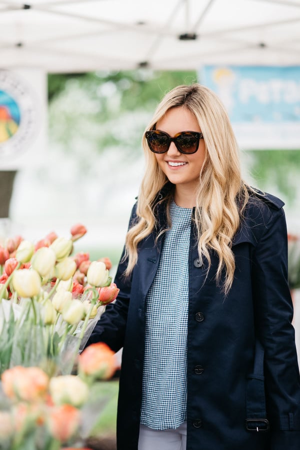 Bows & Sequins at Green City Market in Lincoln Park wearing a navy Tommy Hilfiger trench coat, Celine sunglasses, and a blue gingham top.