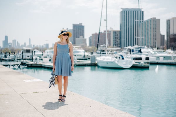 Bows & Sequins at Belmont Harbor in Chicago wearing a blue Old Navy gingham dress, a sun hat from Tuckernuck, Ralph Lauren navy wedges, a J.McLaughlin wicker tote, and a Kate Spade striped silk scarf.