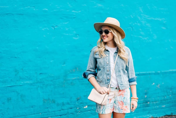 jean jacket, colorful printed shorts, straw sun hat, pink crossbody bag