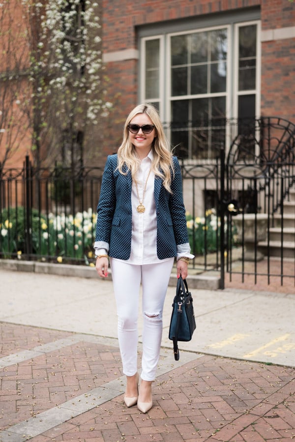Fashion blogger, Jessica Sturdy of bows & sequins, styling an office-appropriate springtime outfit with a polka dot blazer and white jeans. 