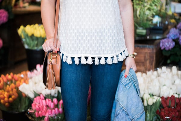 Fashion blogger, Jessica Sturdy, inside of A New Leaf flower shop on Wells Street in Lincoln Park in Chicago. She's wearing an Old Navy tassel top, J Brand jeans, and an Express denim jacket.