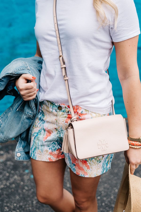tory burch crossbody handbag tassel blush pink, old navy printed shorts, white tee shirt, summer concert outfit