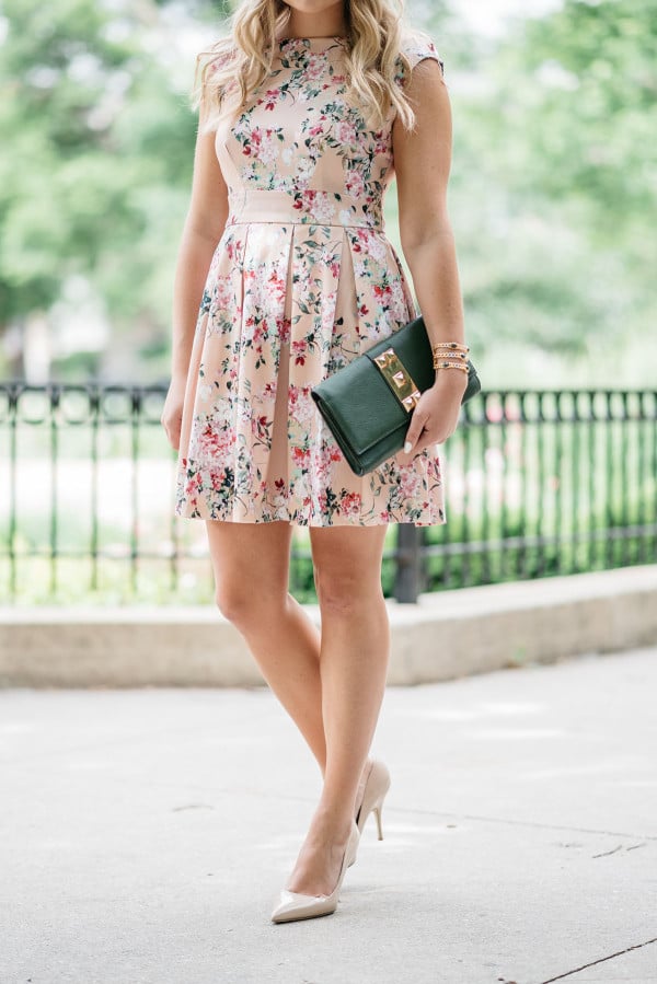 Bows & Sequins wearing a peach floral dress from Modcloth for a summer wedding.
