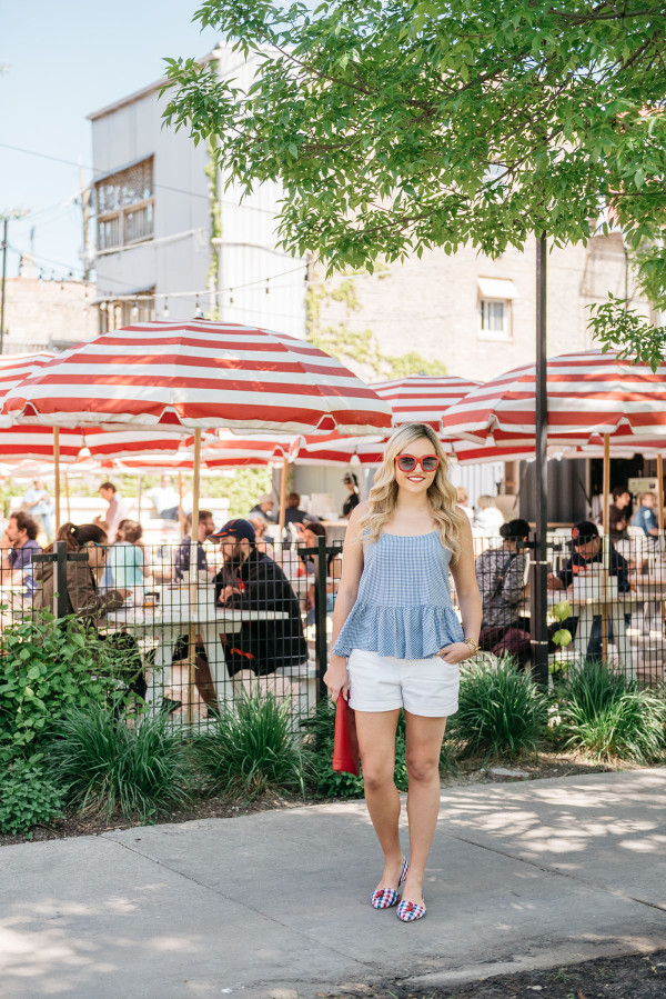Bows & Sequins visits Parson's Chicken and Fish in Chicago. Jessica is wearing a blue and white Old Navy gingham top, white jeans shorts, red and blue gingham flats from Souther Proper, a red Sole Society clutch, and red sunglasses. A good outfit for Fourth of July weekend!