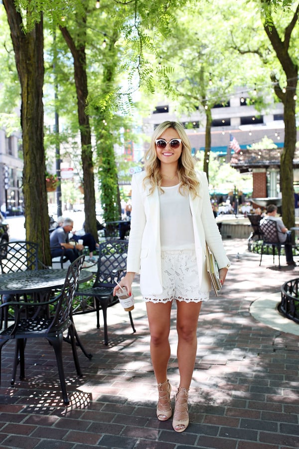 Bows & Sequins wearing an all-white outfit that's perfect for going from the workday to dinner and drinks! Pair a long-line white blazer with a silky tank, lace shorts, and lace-up heels for a chic summertime look.