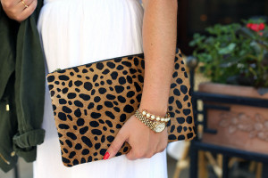 Bows & Sequins wearing a white maxi dress that's perfect for summer vacations! Dress it up at night with wedges and a printed leopard clutch. This calfhair clutch is from Clare V!