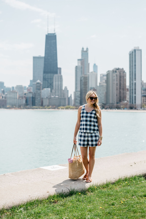 Bows & Sequins wearing a gingham short set having a picnic at North Avenue Beach with the Chicago Skyline in the background.