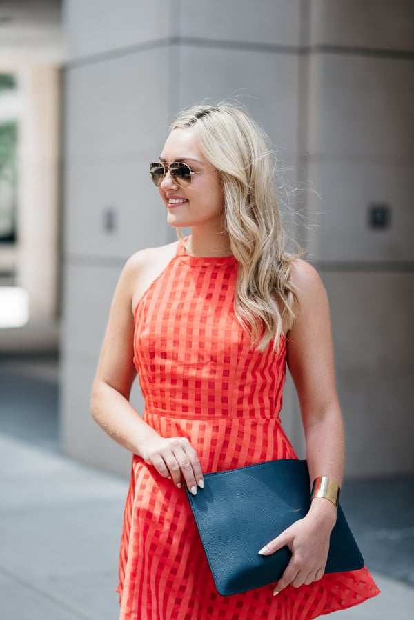 Bows & Sequins wearing a Lovers + Friends red-orange backless dress. Perfect dress for a warm night out on the town!
