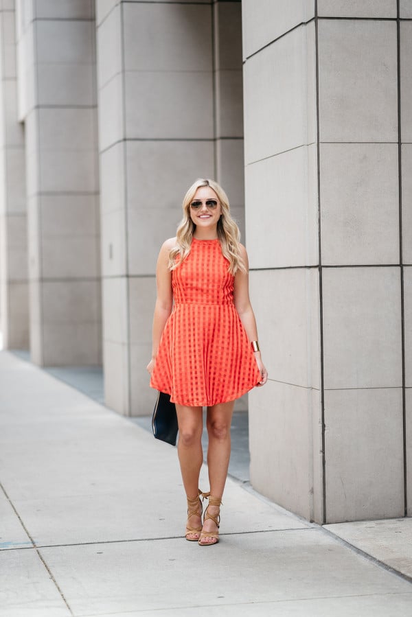 Bows & Sequins wearing a Lovers + Friends red-orange backless dress. Perfect dress for a warm night out on the town!