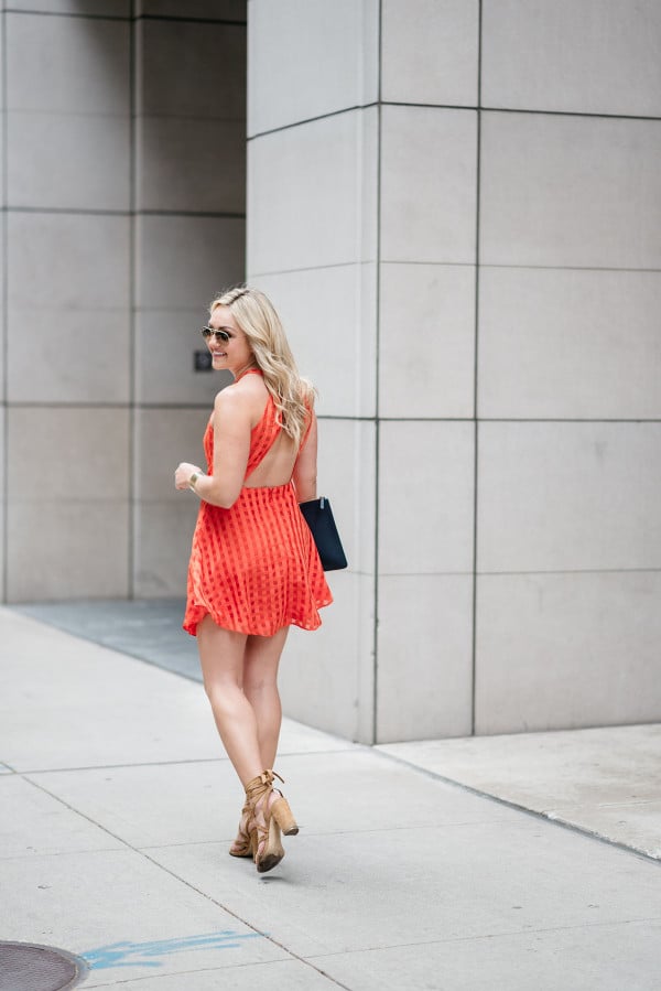 Bows & Sequins wearing a Lovers + Friends red-orange backless dress. Perfect dress for a warm night out on the town!