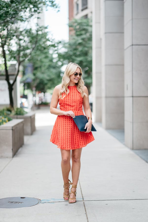 Bows & Sequins wearing a Lovers + Friends red-orange backless dress. Perfect dress for a warm night out on the town!