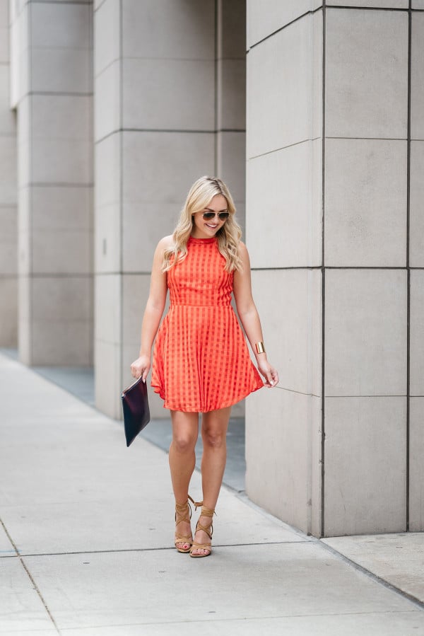 Bows & Sequins wearing a Lovers + Friends red-orange backless dress. Perfect dress for a warm night out on the town!