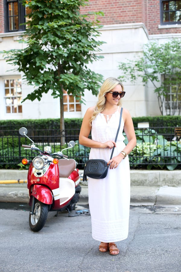 Bows & Sequins wearing a white maxi dress that's perfect for summer vacations! Dress it up at night with wedges and a printed clutch or keep it casual for sightseeing with a crossbody and a pair of flat leather sandals.
