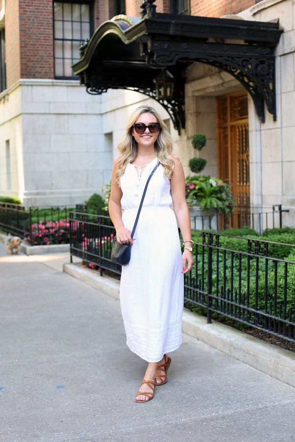 Bows & Sequins wearing a white maxi dress that's perfect for summer vacations! Dress it up at night with wedges and a printed clutch or keep it casual for sightseeing with a crossbody and a pair of flat leather sandals.