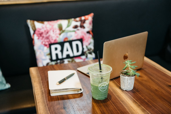 Left Coast Food in Chicago is one of @bowsandsequins' favorite spots for healthy eating and working remotely. Jessica's workday essentials are pictured here: a GigiNY leather journal and a gold Apple Macbook.