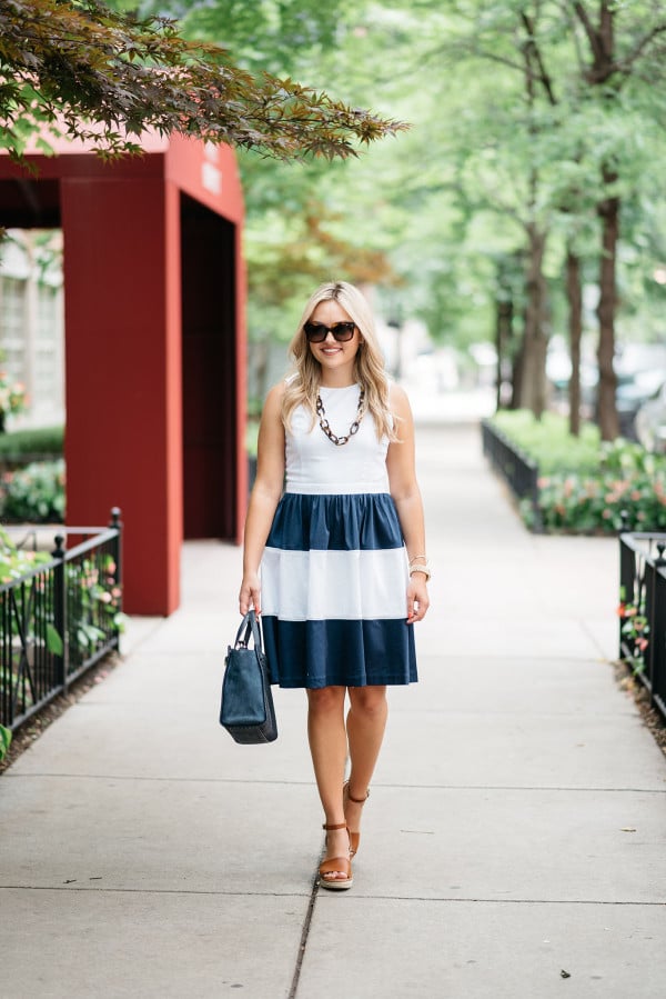 Blogger @bowsandsequins wearing a navy and white striped Elizabeth McKay dress with leather espadrille wedges, Celine sunglasses, a navy blue Kate Spade bag, and a tortoise link necklace.