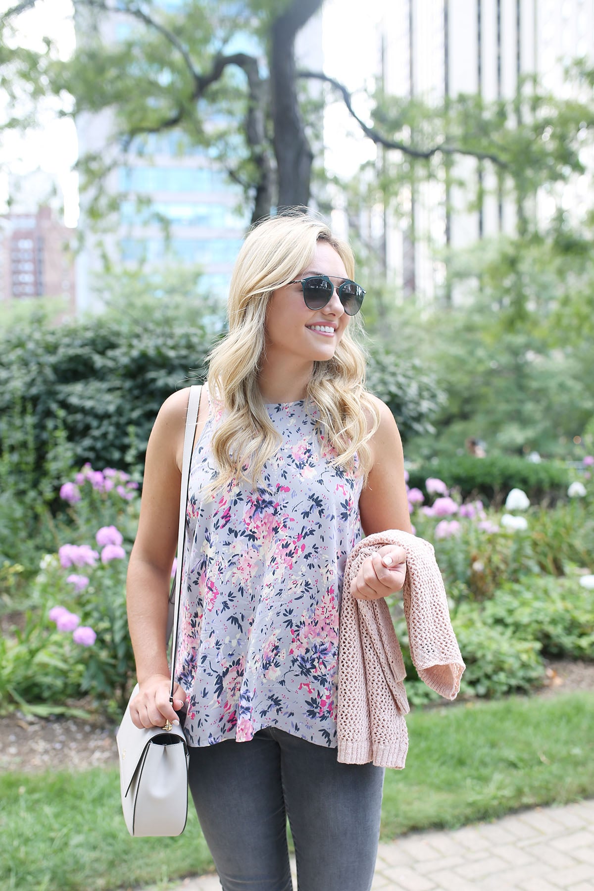 Bows & Sequins wearing a floral paisley-printed top from Old Navy, a Kate Spade crossbody bag, and Dior sunglasses.
