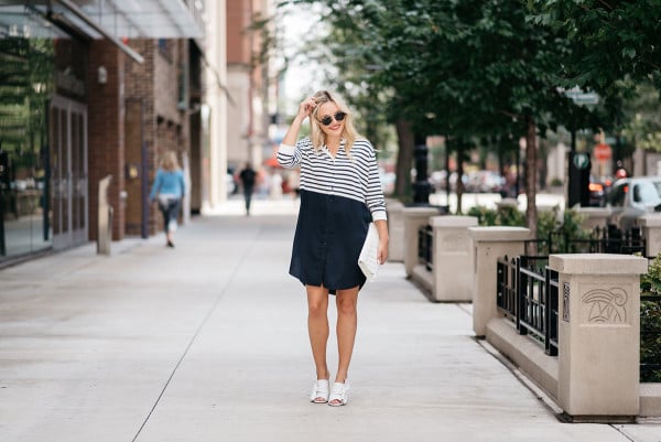 Jessica Sturdy of the fashion blog Bows & Sequins styling a COS striped t-shirt dress, white bow shoes, sunglasses and a white purse.