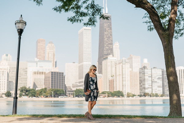 Fashion blogger Bows & Sequins wearing a navy floral dress, Old Navy grey sweater, and booties in the Windy City.