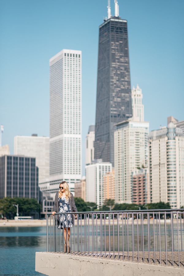 Fashion blogger Bows & Sequins wearing an Old Navy floral cami dress, grey sweater, booties, clutch, and aviators in Chicago.