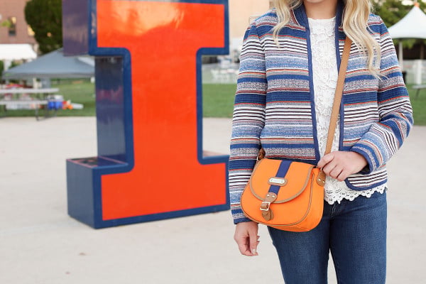 Bows & Sequins styling an outfit that's perfect for a cool college gameday! Orange & Blue striped jacket, lace tank, jeans, and a crossbody bag in school colors.
