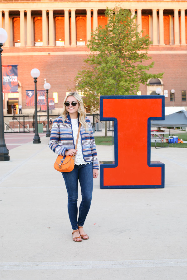 Bows & Sequins styling an outfit that's perfect for a cool college gameday! Orange & Blue striped jacket, lace tank, jeans, and a crossbody bag in school colors.