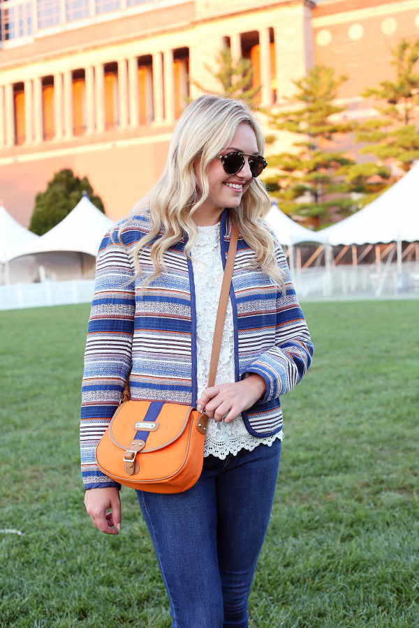 Bows & Sequins styling an outfit that's perfect for a cool college gameday! Orange & Blue striped jacket, lace tank, jeans, and a crossbody bag in school colors.
