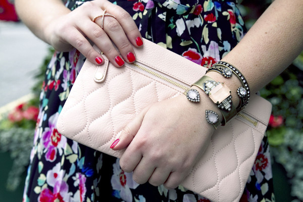 Style blogger Bows & Sequins styling a blush leather clutch purse with Loren Hope bracelets in London.