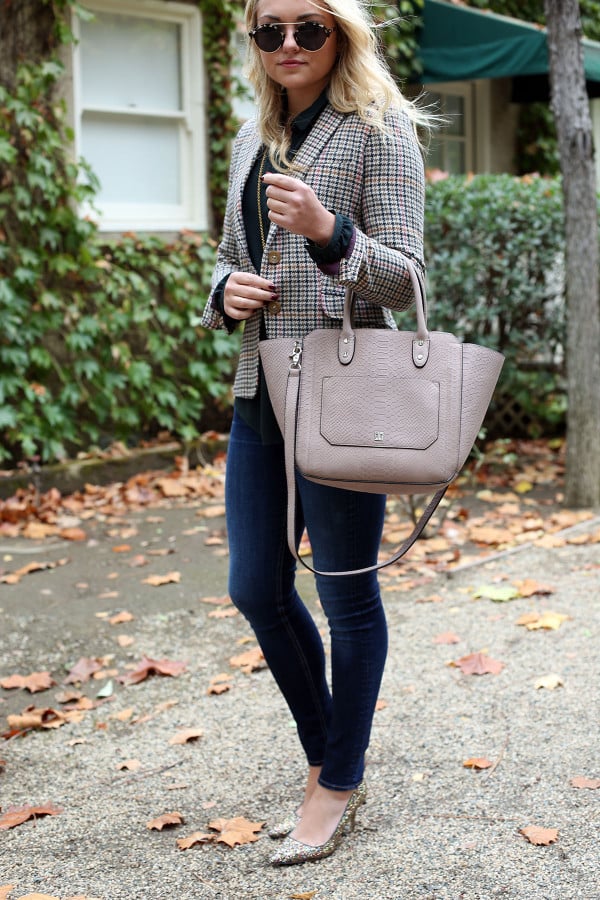 Fashion blogger Bows & Sequins styling a plaid blazer, skinny jeans, and glitter pumps for the office.
