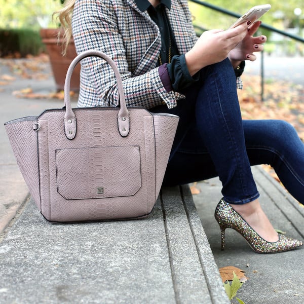 Fashion blogger Bows & Sequins styling a plaid blazer, skinny jeans, and glitter pumps for the office.