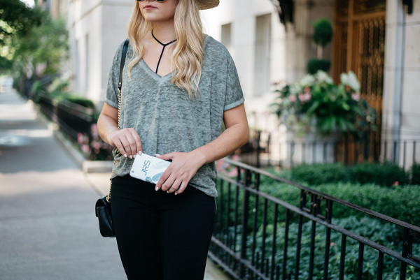 Bows & Sequins styling a casual outfit for fall. Janessa Leone Hat, Oversized Tee, Strappy Bralette, Frame Jeans