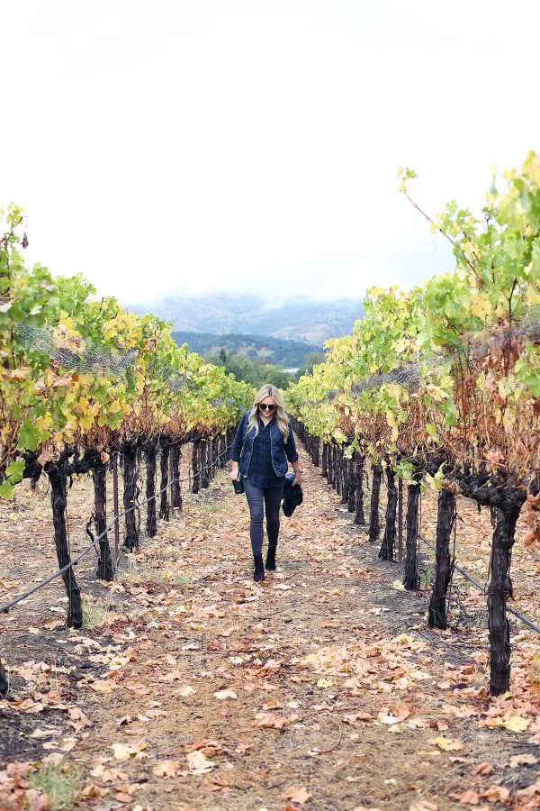 Bows & Sequins wearing a plaid shirt, quilted vest, and a blanket scarf in Napa, California.