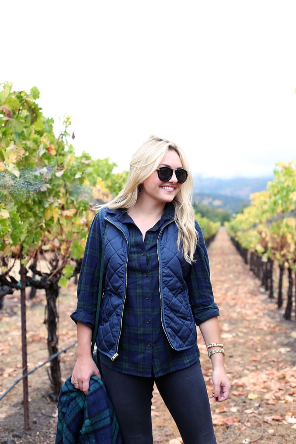 Bows & Sequins wearing a plaid shirt, quilted vest, and a blanket scarf in Napa, California.