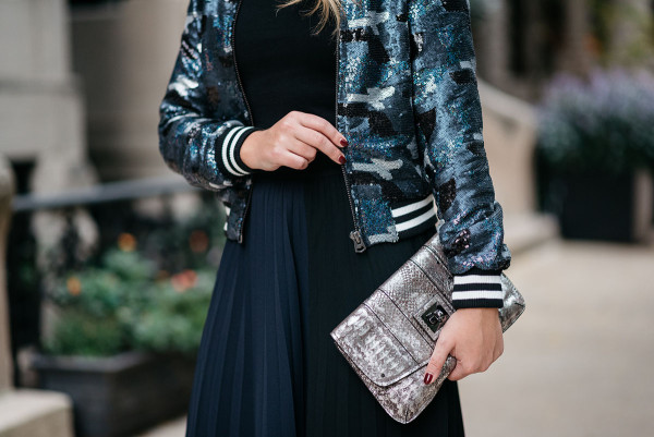 Bows & Sequins styling a sequin bomber jacket and pleated colorblocked midi skirt.