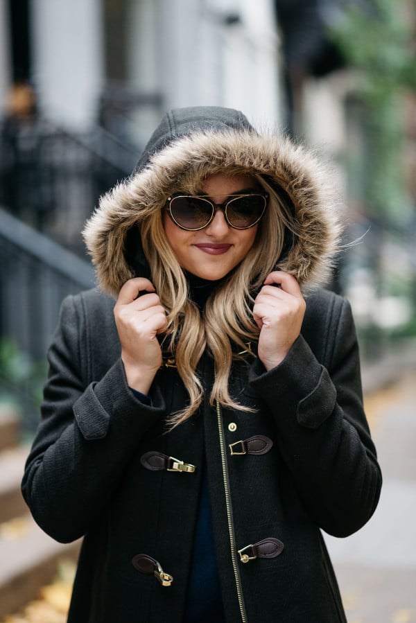 Bows & Sequins wearing a fur-trimmed Cole Haan coat and Tom Ford sunglasses.