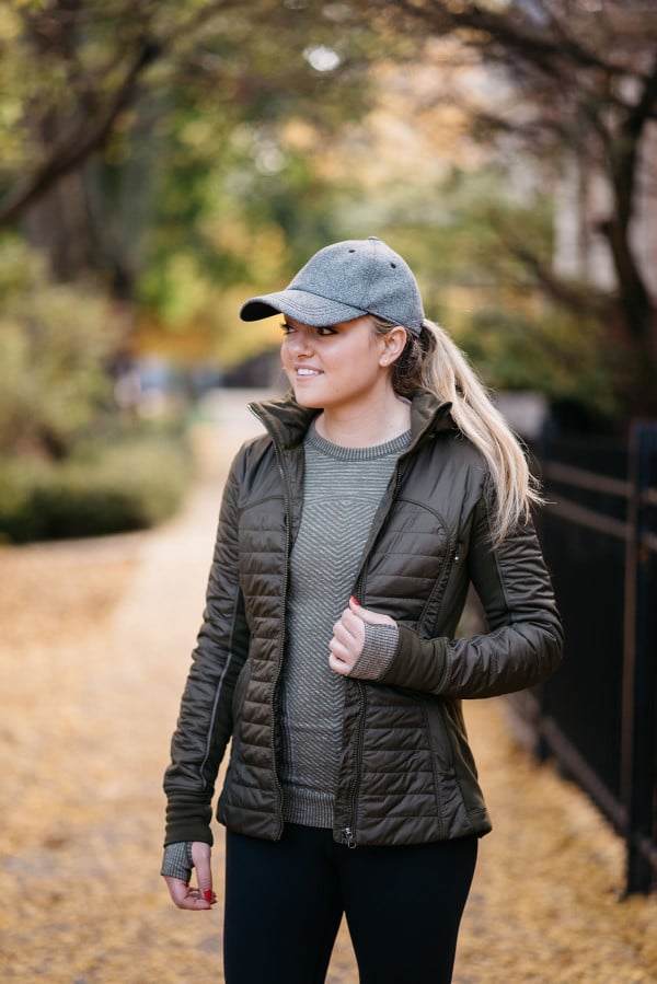 Bows & Sequins wearing a lululemon Baller Hat, First Mile Jacket, and lululemon crewneck tee in Lincoln Park in Chicago.