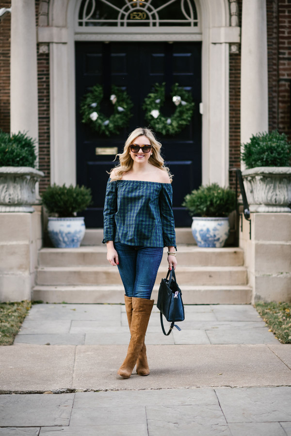 Bows & Sequins wearing an off-the-shoulder plaid shirt with skinny jeans and over-the-knee boots.